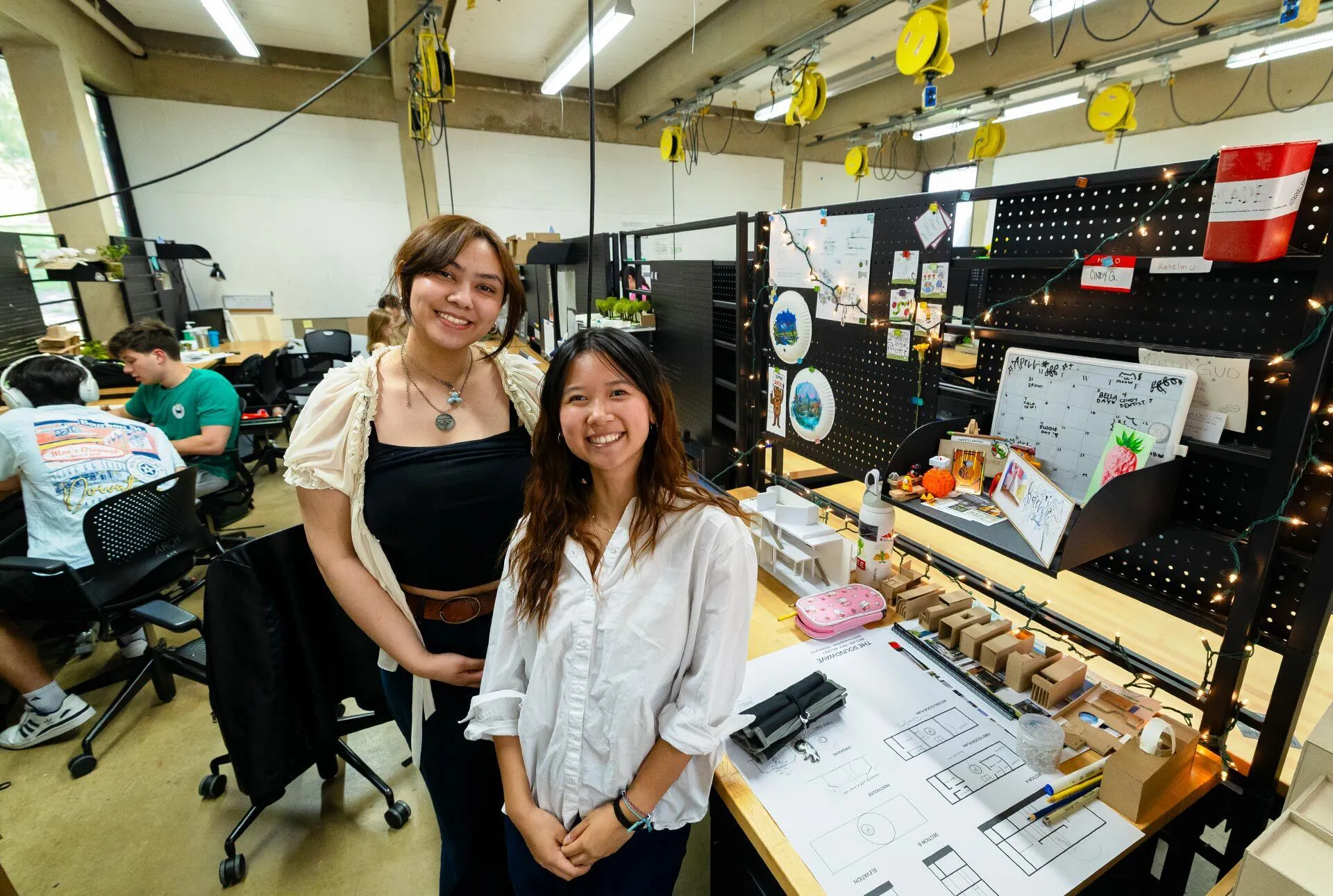 Katelyn Bowman and Cindy Guo post at their shared desk