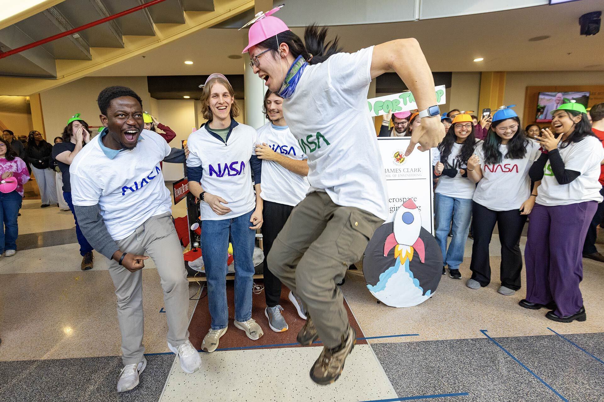 students jump and celebrate