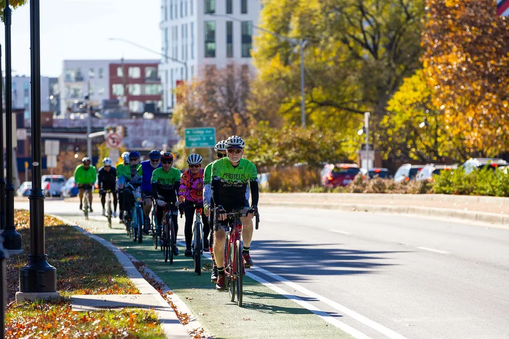 bicyclists bicycles along a bicycle lane that is painted green