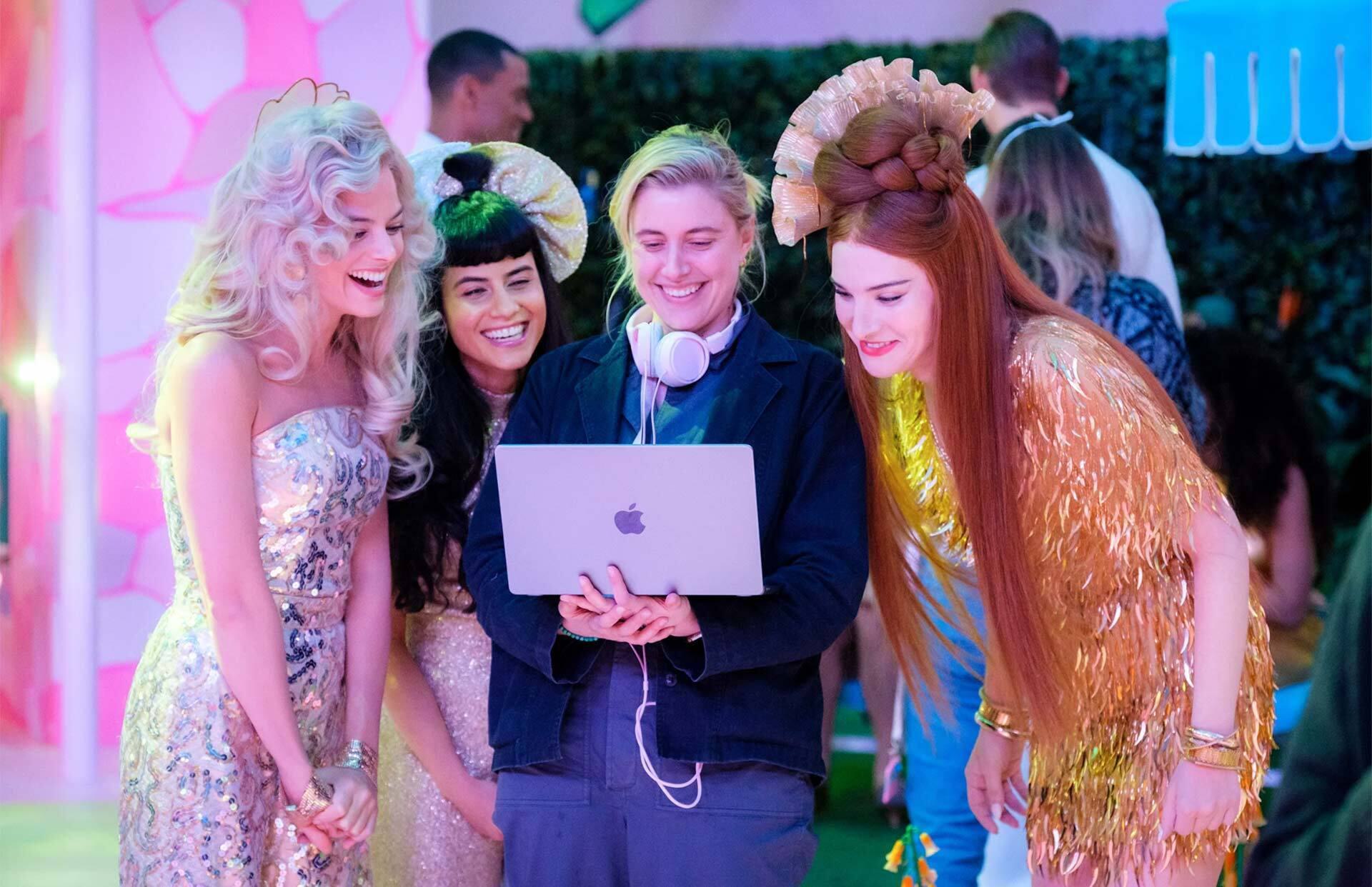 actors on "Barbie" set surround Greta Gerwig