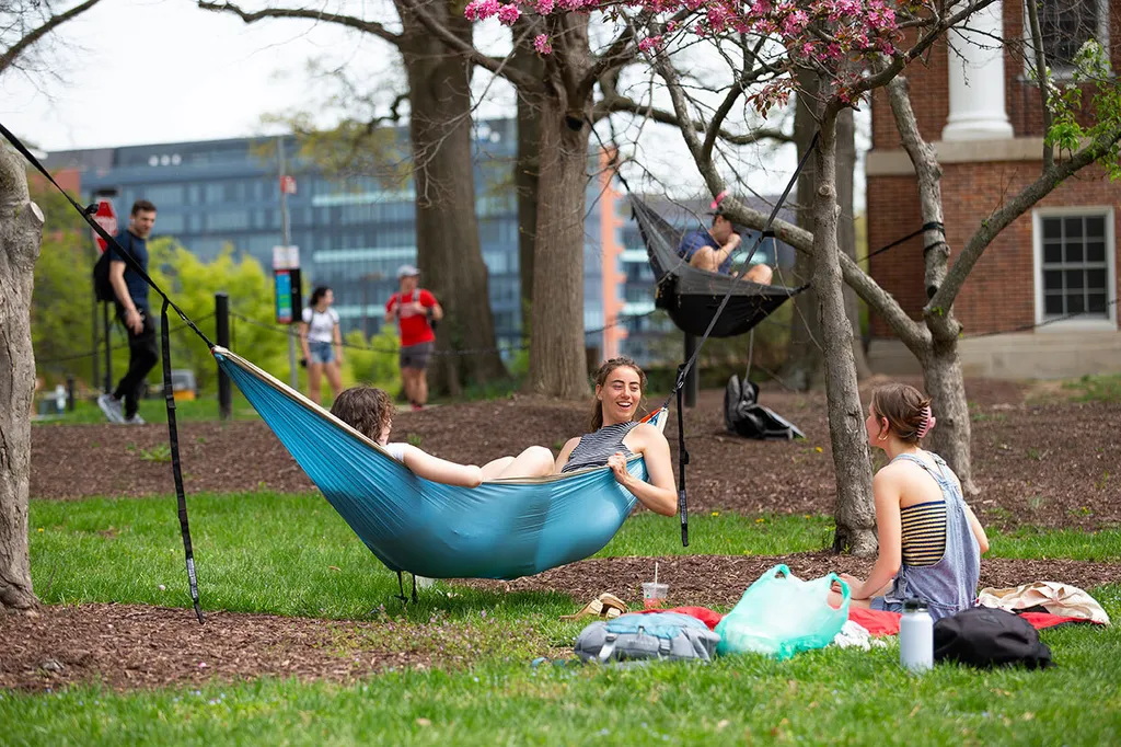 Students lie in hammock on McKeldin Mall