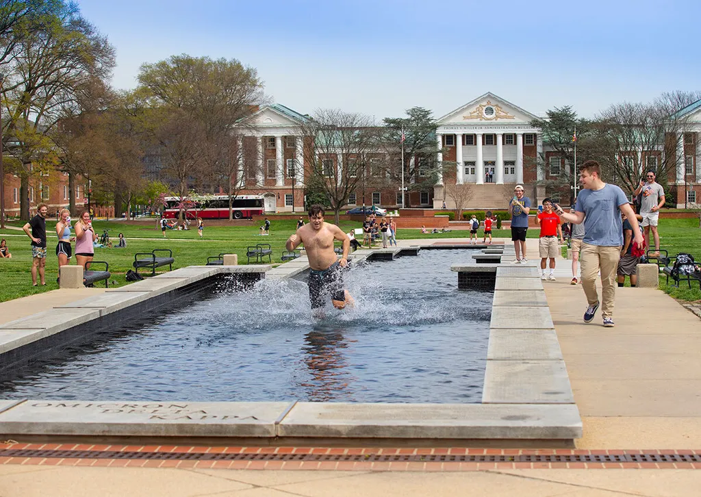 Student runs through ODK Fountain