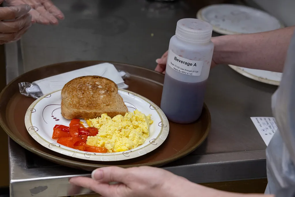 plate with eggs, toast and red peppers, with "Beverage A" also on the tray