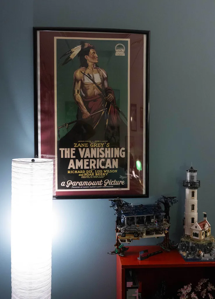 A poster for "The Vanishing American" movie in front of a vertical lamp and Lego diorama of "Stranger Things"