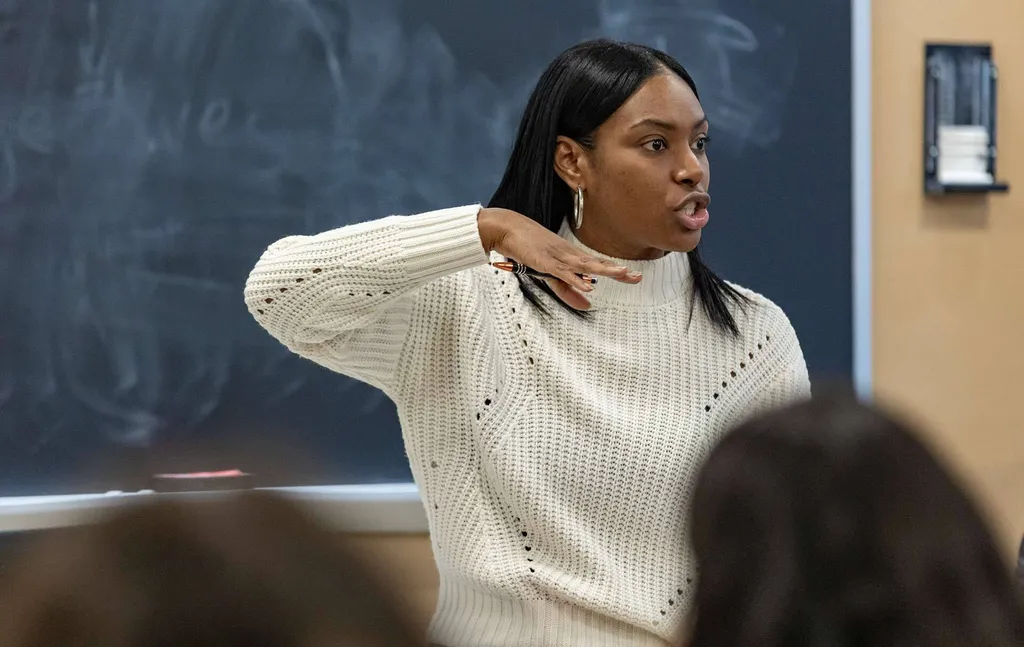 woman teaches in front of class