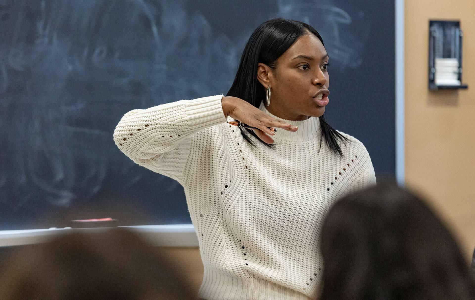 woman teaches in front of class