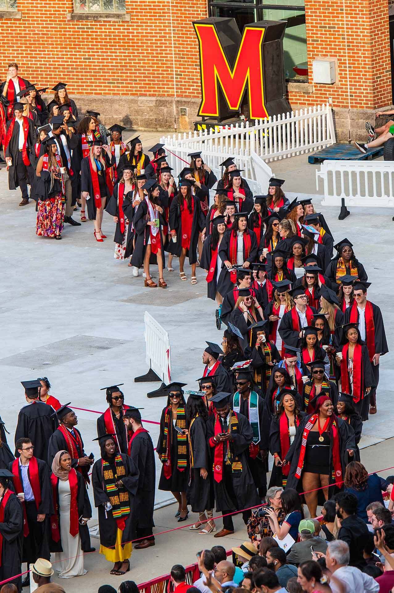 graduates line up outside the stadium