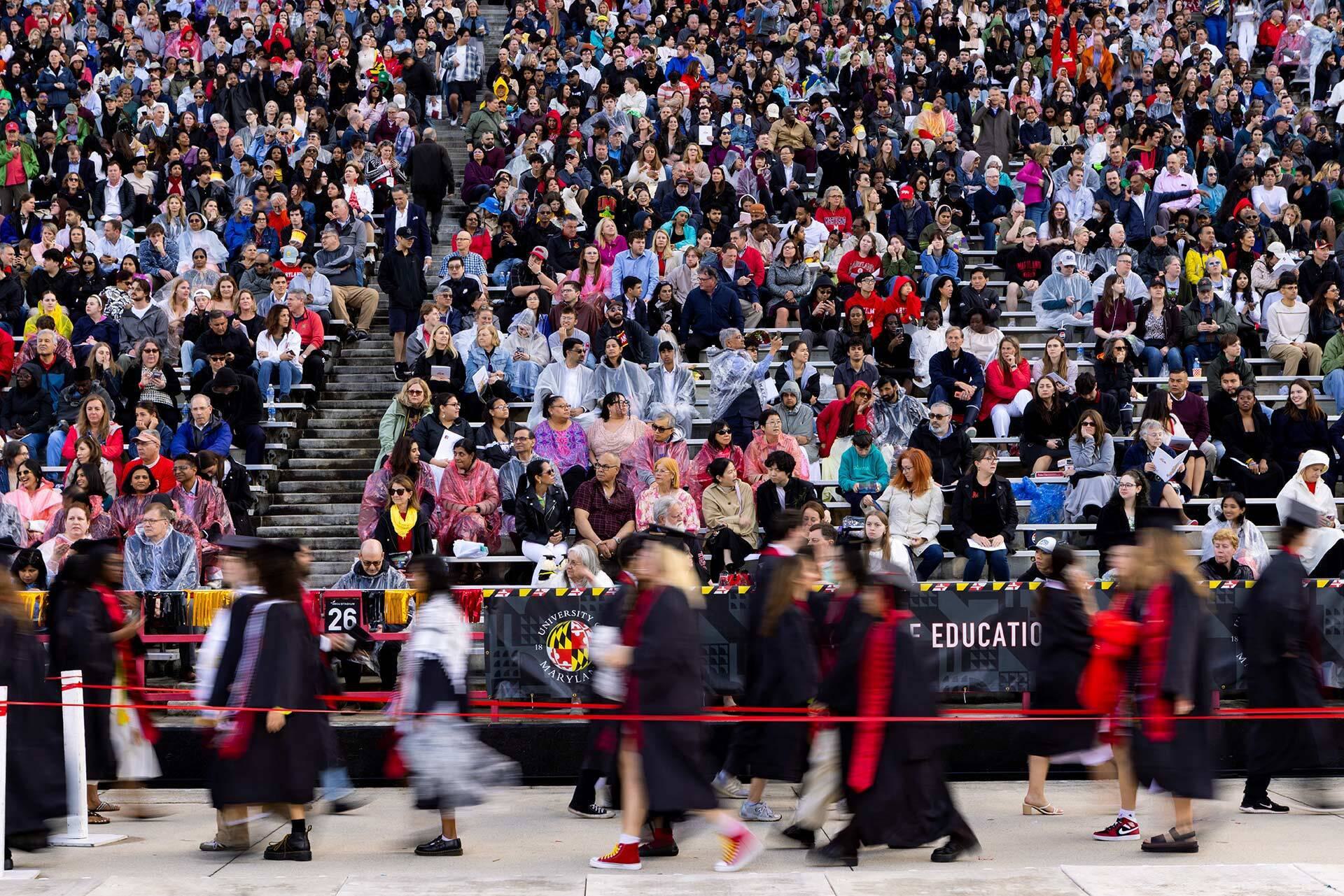 blurred graduates enter SECU Stadium