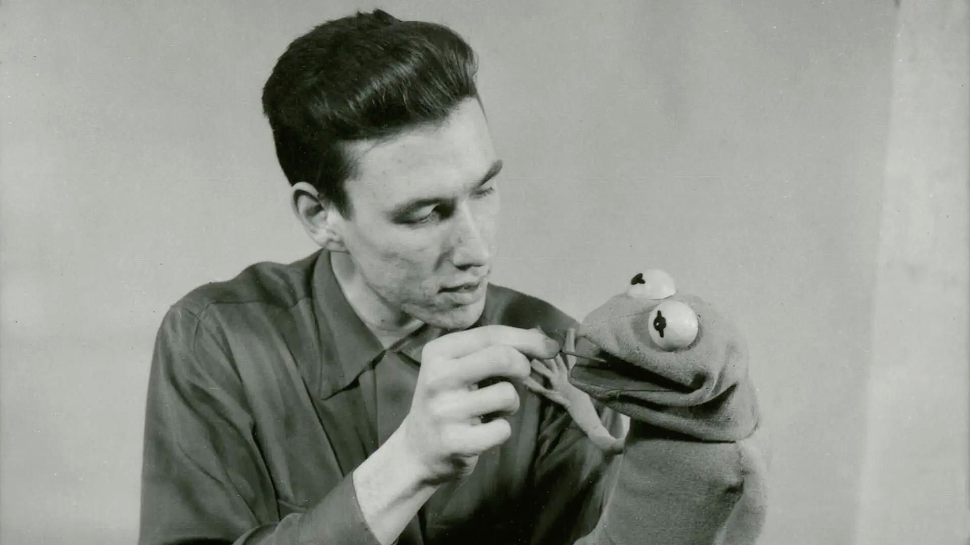 Black and white photo of a young Jim Henson with the first iteration of Kermit the Frog