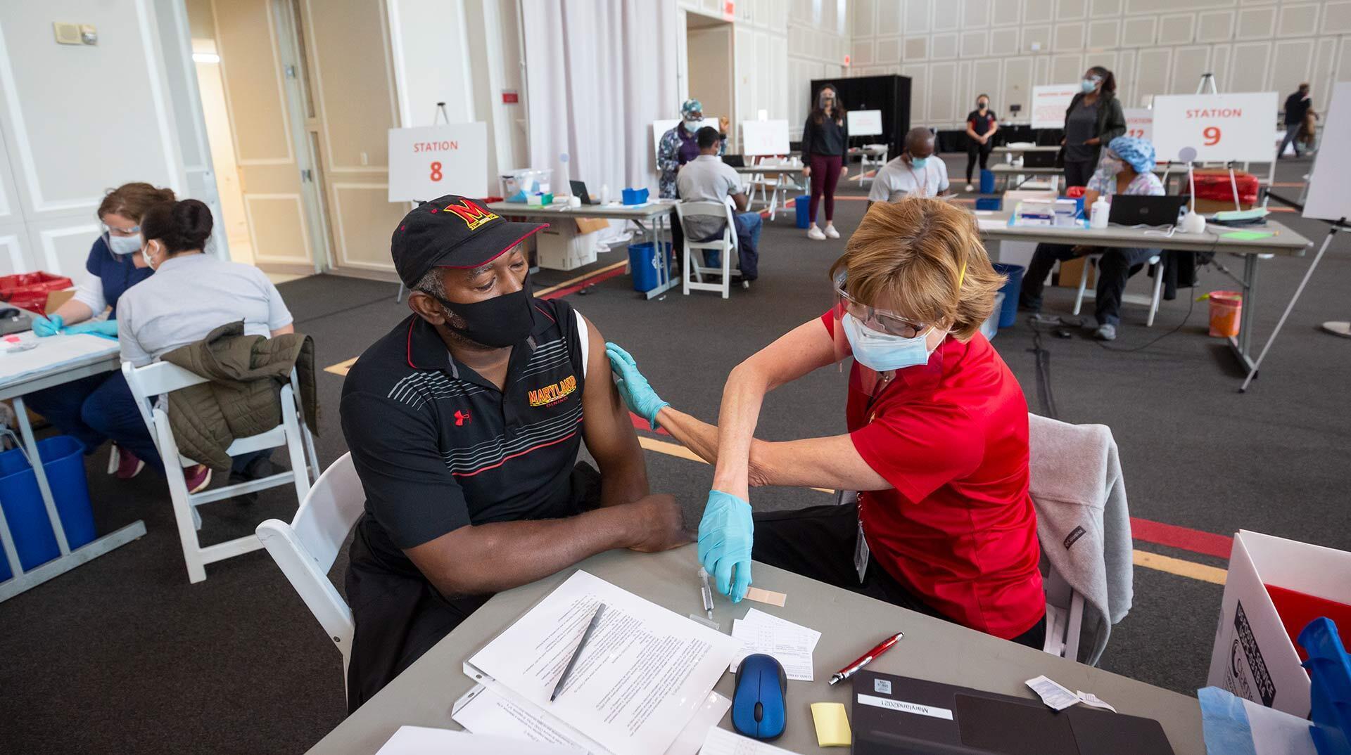 Man receives COVID-19 vaccine