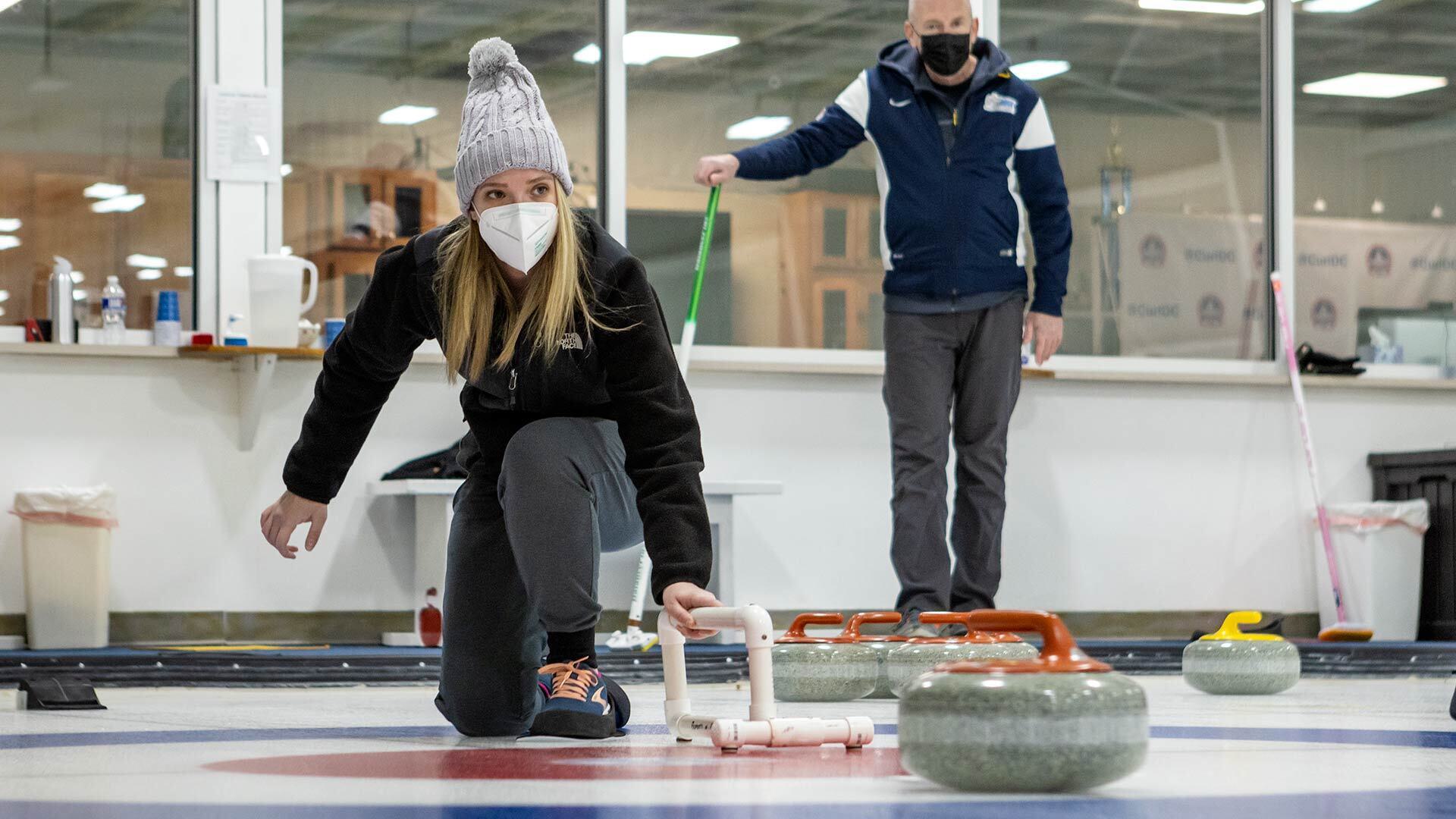 Curler slides granite rock