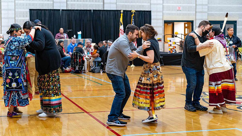 people do a potato dance at the pow wow, with potatoes held between their foreheads