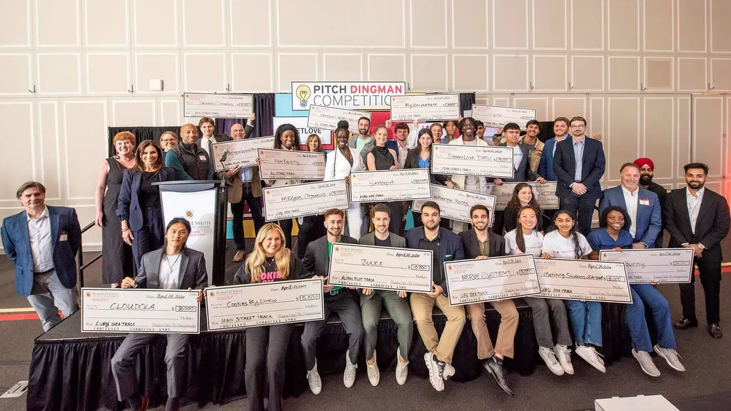 Pitch Dingman Competition winners hold up giant checks
