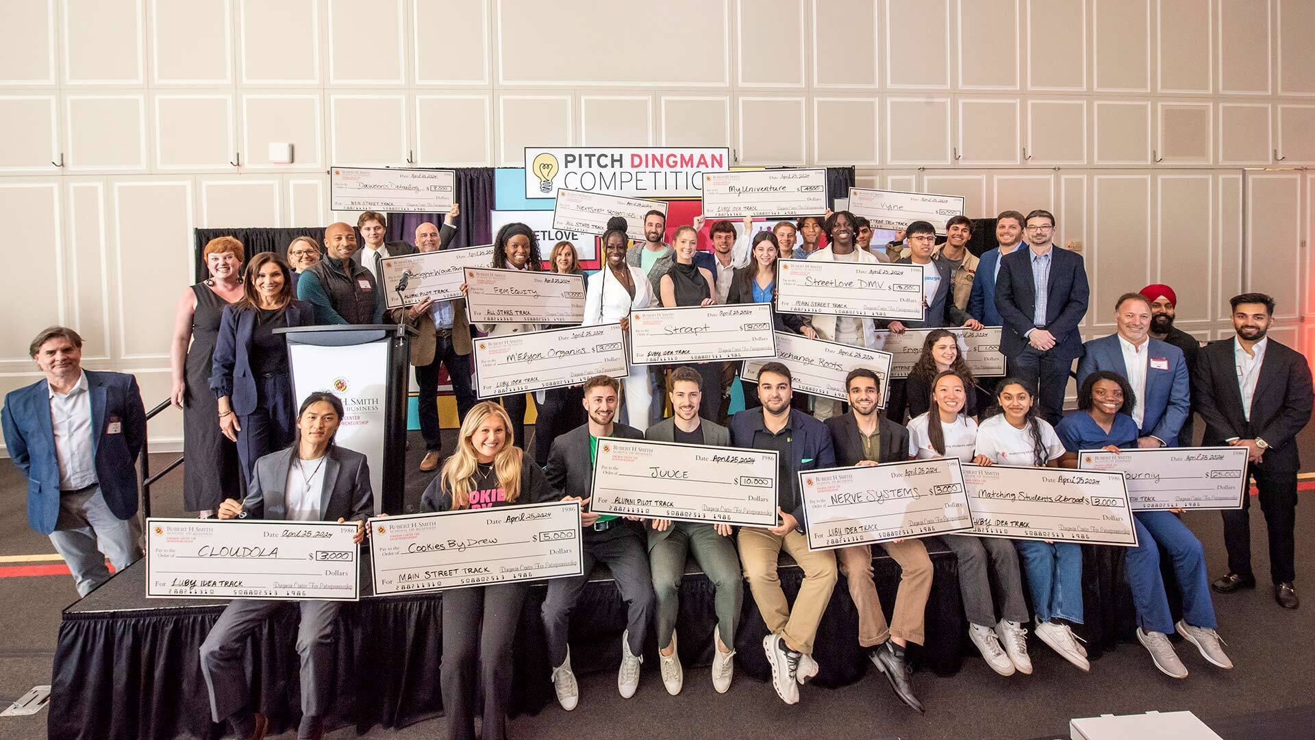 Pitch Dingman Competition winners hold up giant checks