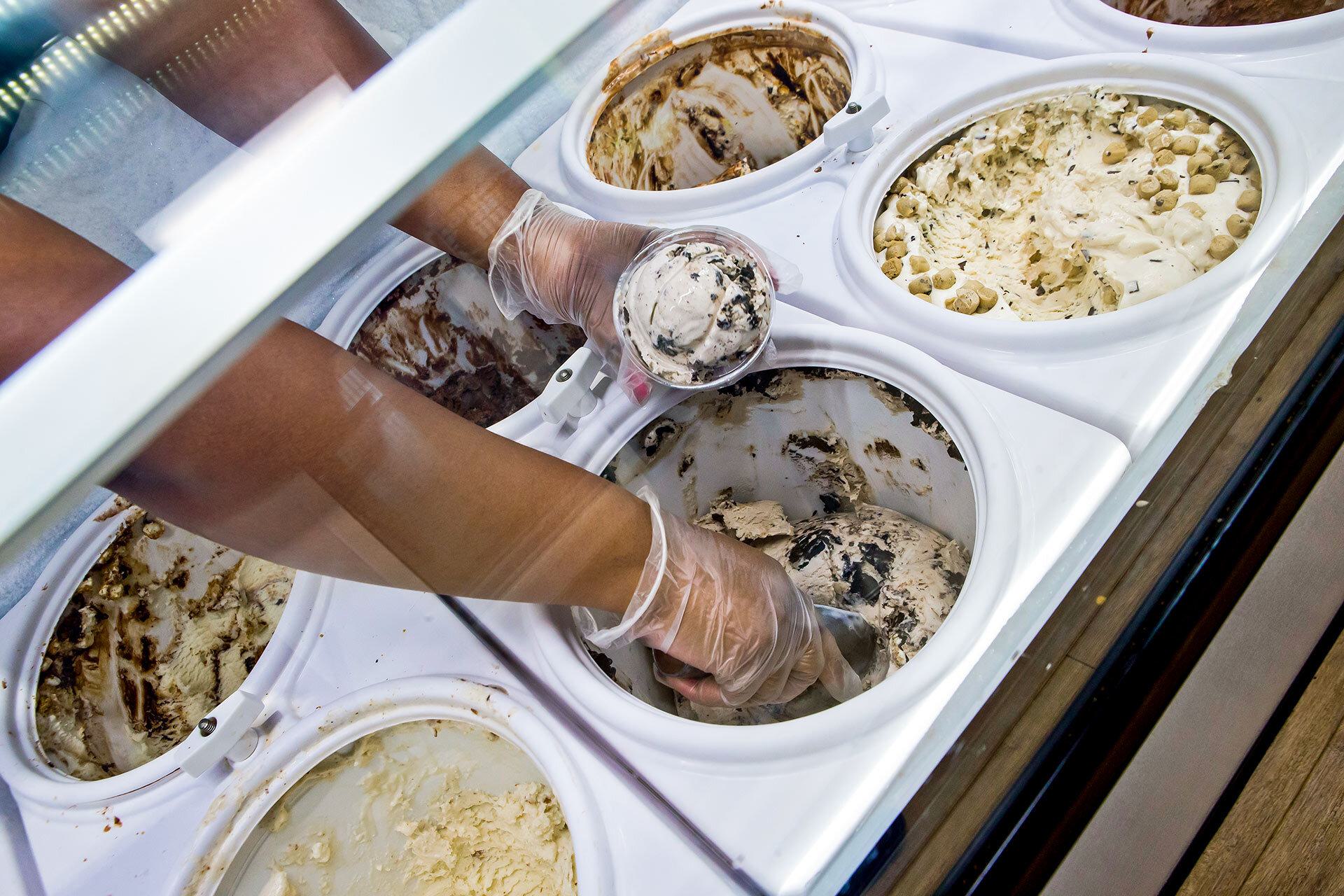 closeup of hands scooping ice cream