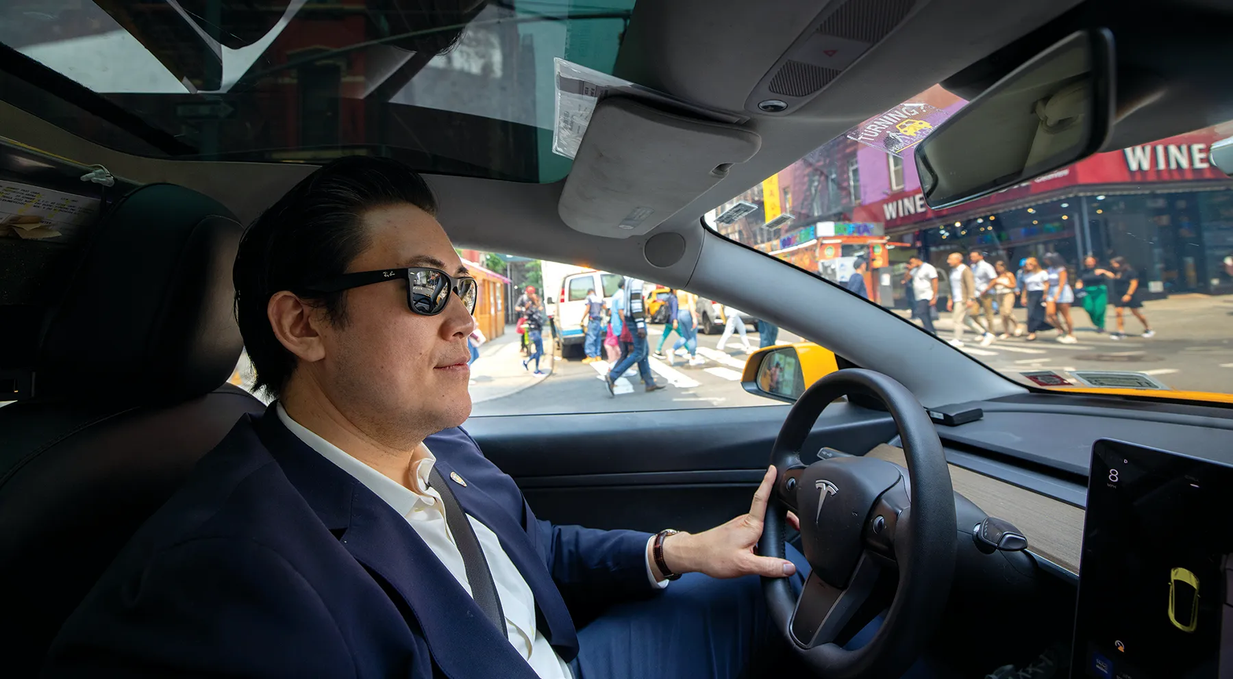 David Do drives a taxi wearing sunglasses