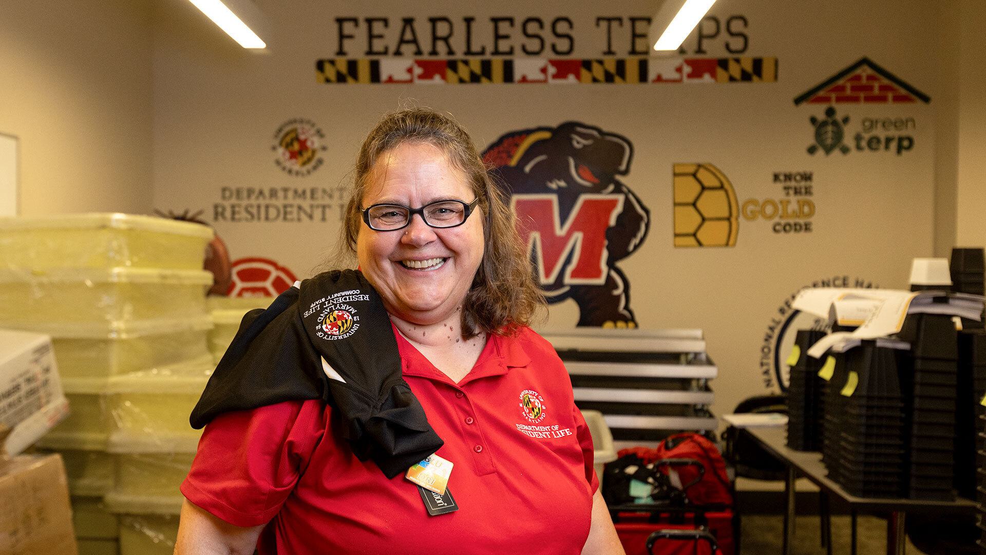 Donna Metz poses with UMD gear and supplies