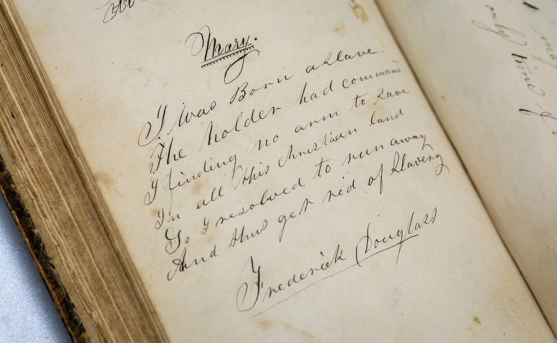 handwritten poem that reads, "I was born a slave / The holder had command / I finding no arm to save / In all this christian land / So I resolved to run away / And thus get rid of slavery," with Frederick Douglass' signature