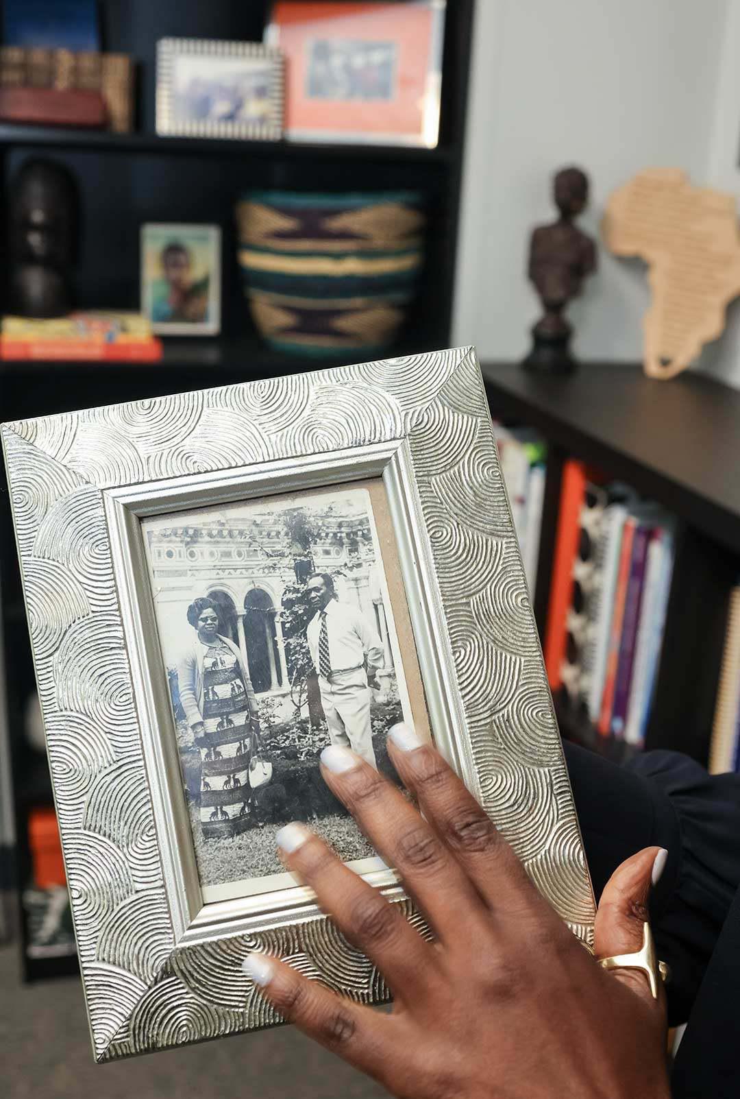 hand points to framed picture