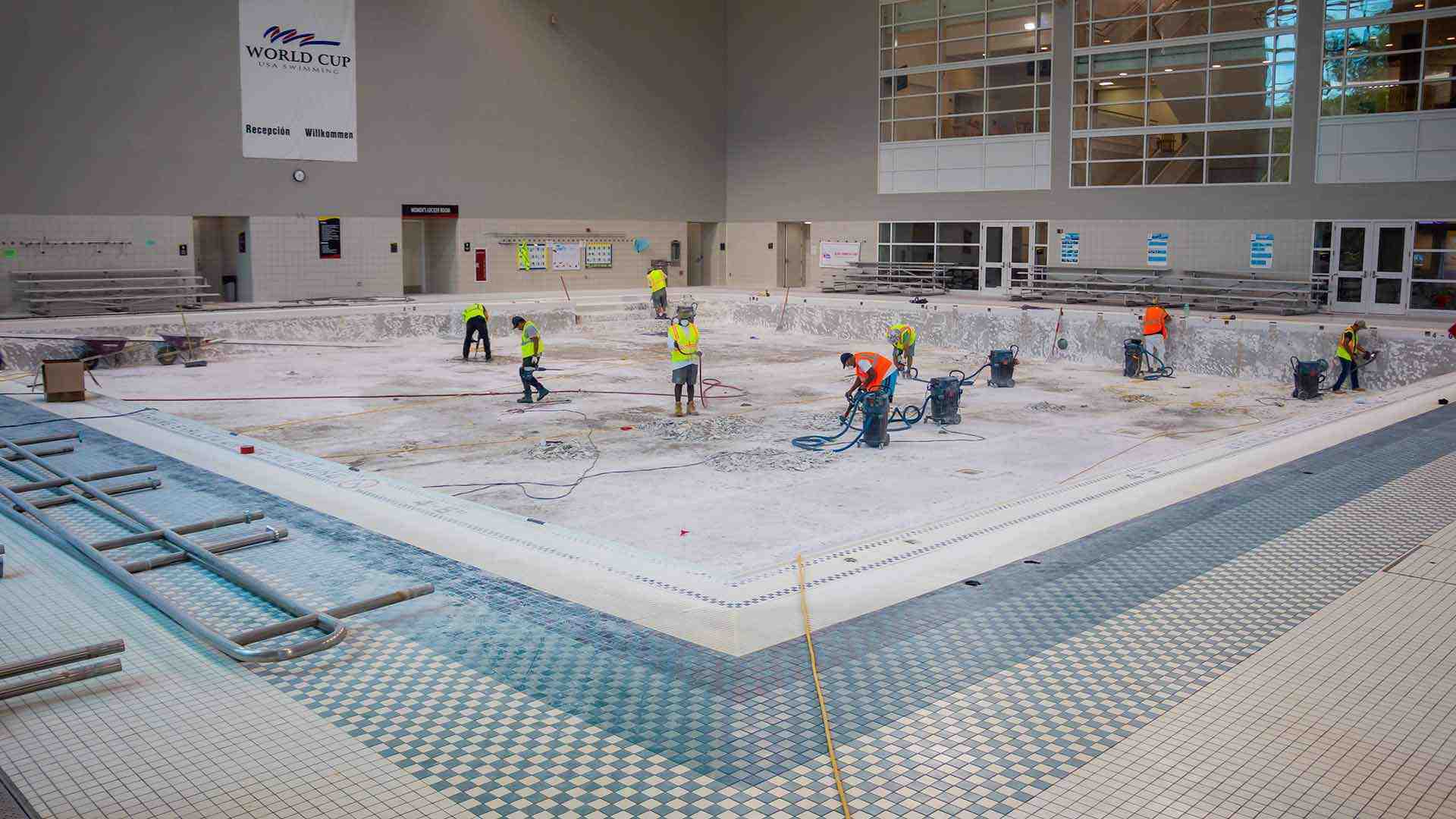 Staffers work in empty pool
