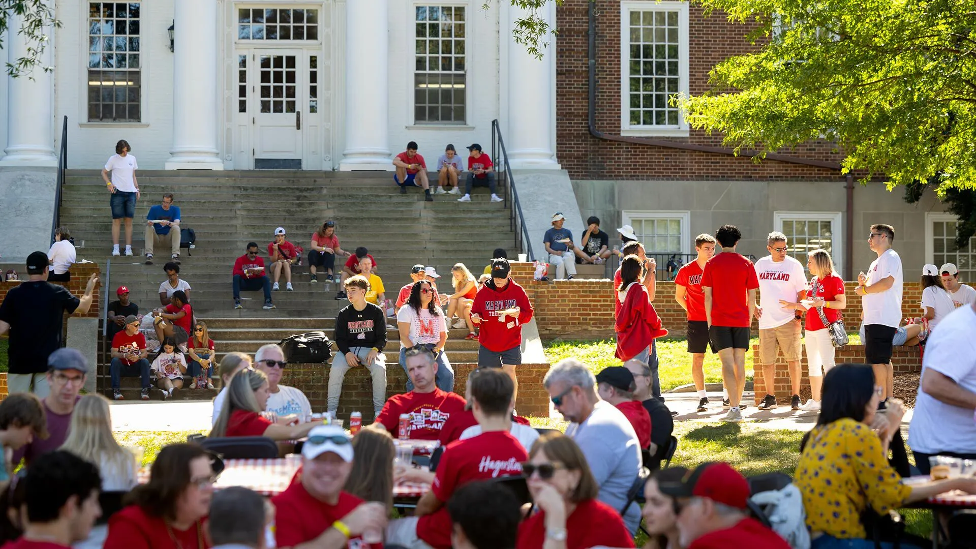 A crowd of families gathers on McKeldin Mall to socialize and eat