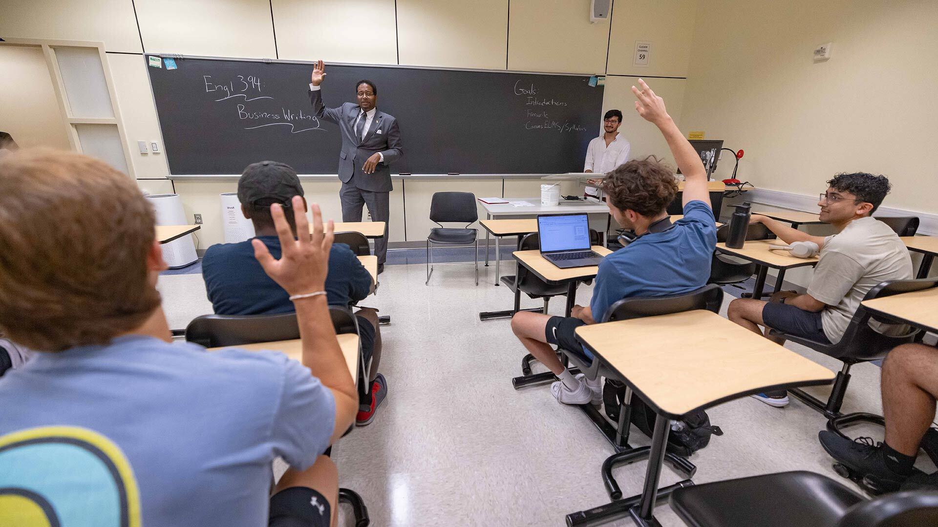 Pines raises hand in front of Business Writing class