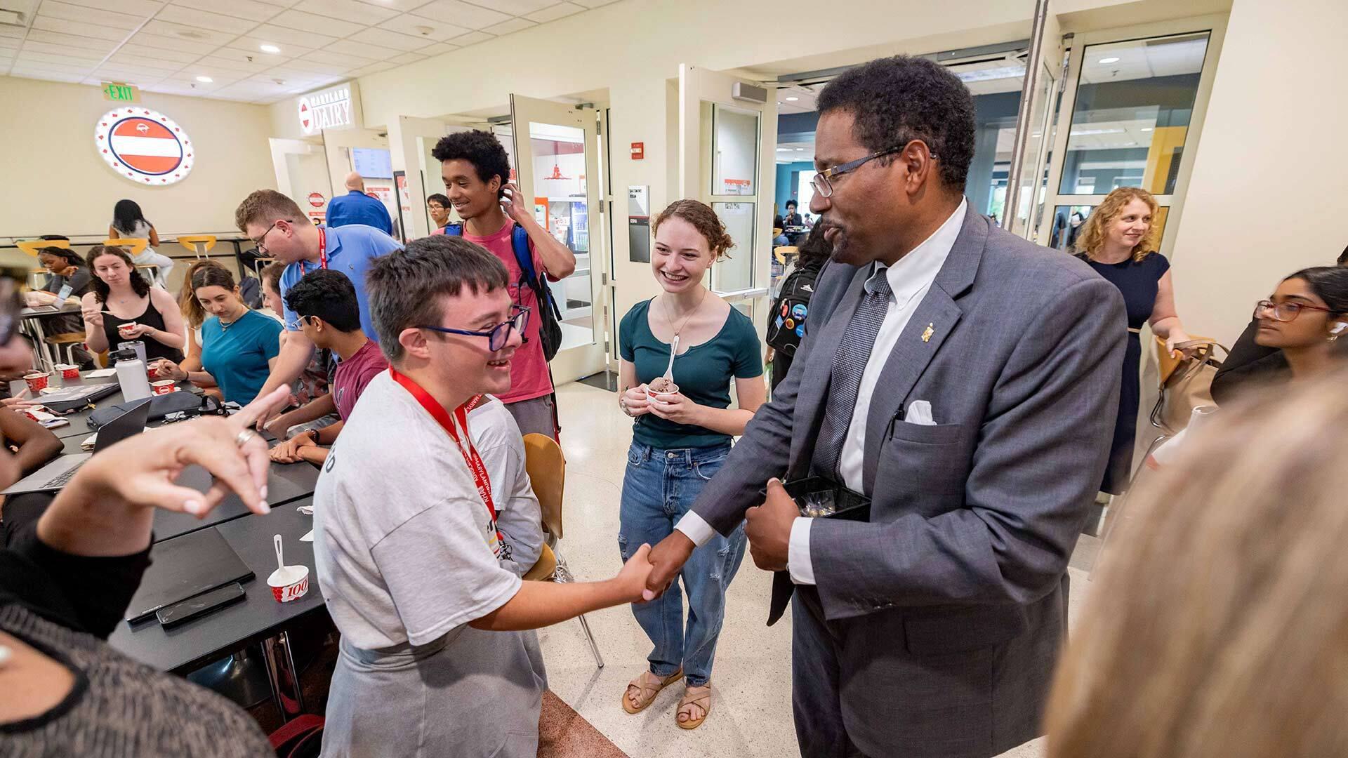 Pines shakes student's hand at Maryland Dairy