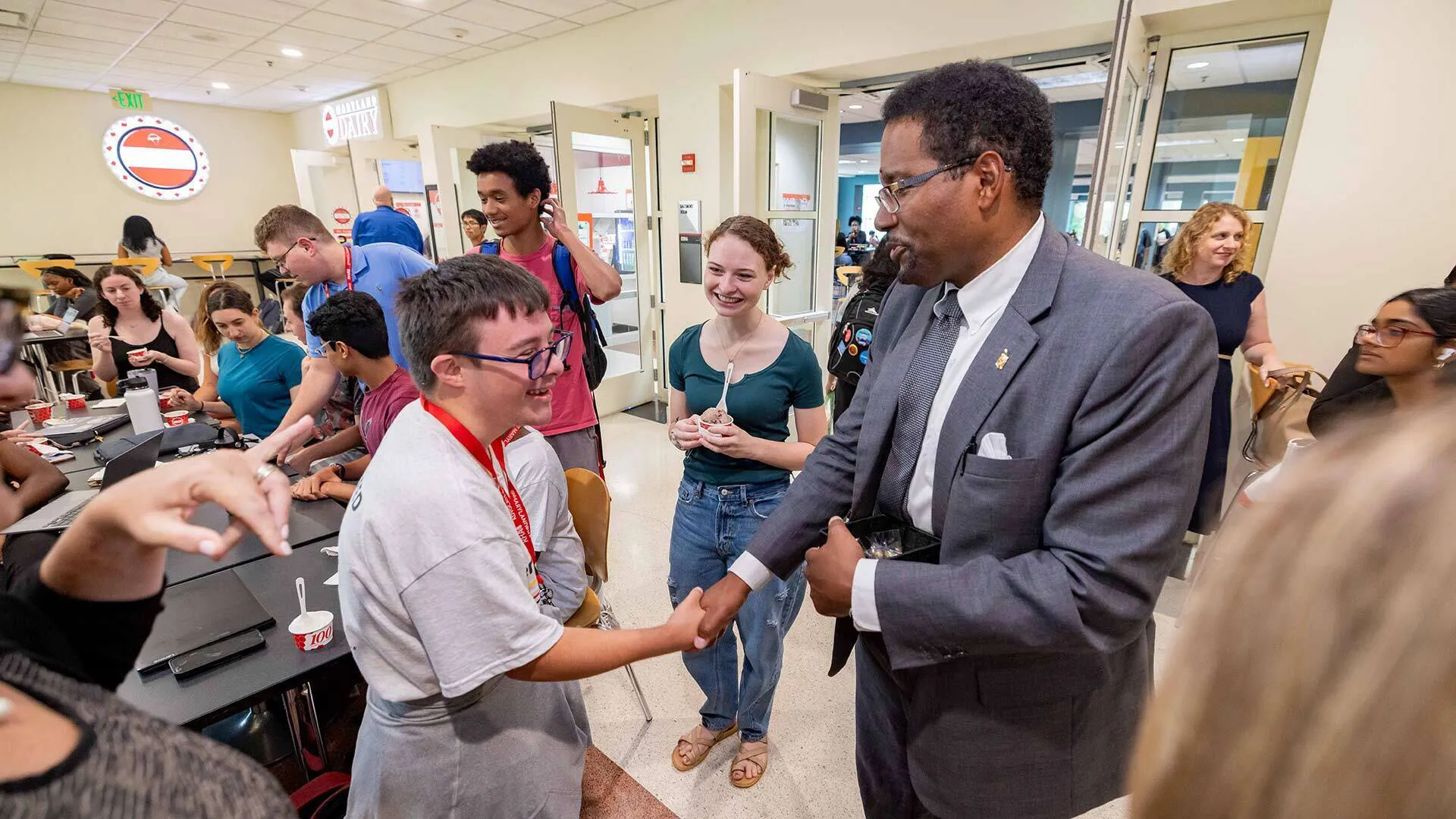 Pines shakes student's hand at Maryland Dairy