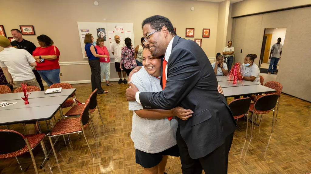 Pines hugs staff member