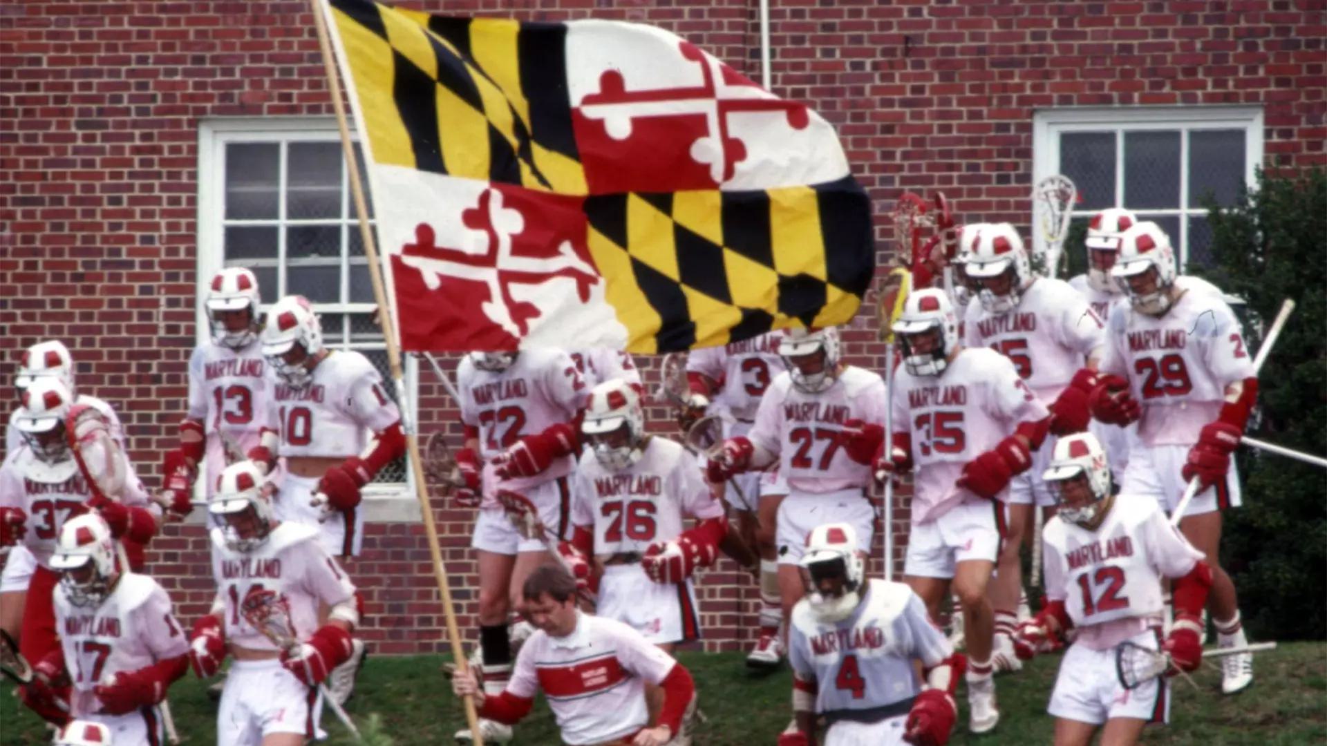 lacrosse players carry Maryland flag