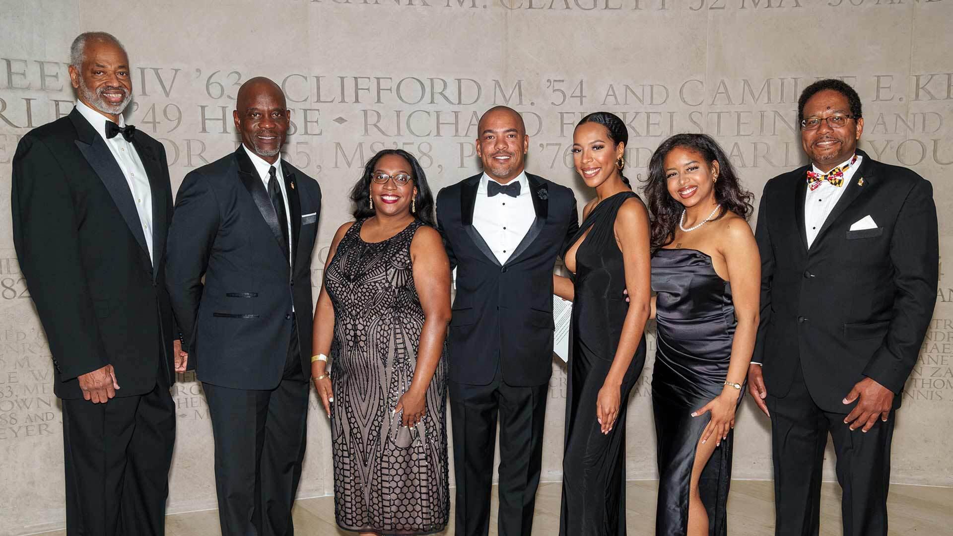 Len Elmore '78, James Brown '82, Cherisse McKenzie '10, Scott Simpson '93, Lauren Hamilton '22, Iyana Moore '22 and President Pines