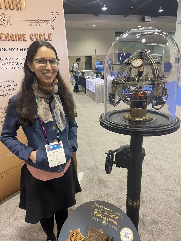 Nicole Yunger Halpern with quantum steampunk sculpture in glass display case
