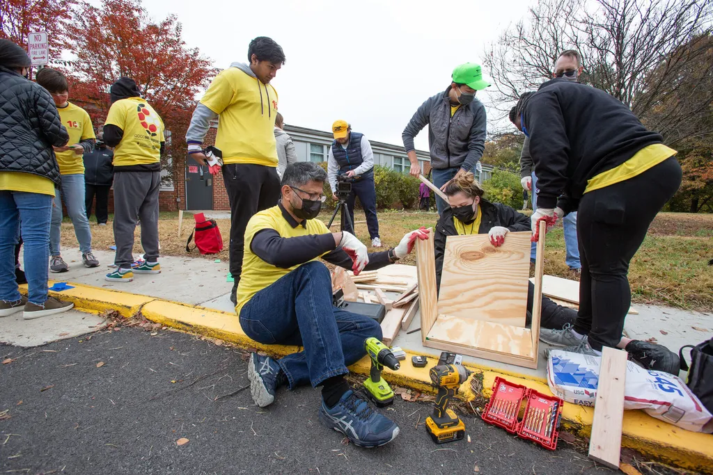 Volunteers create a book box to install in front of Hollywood Elementary in College Park