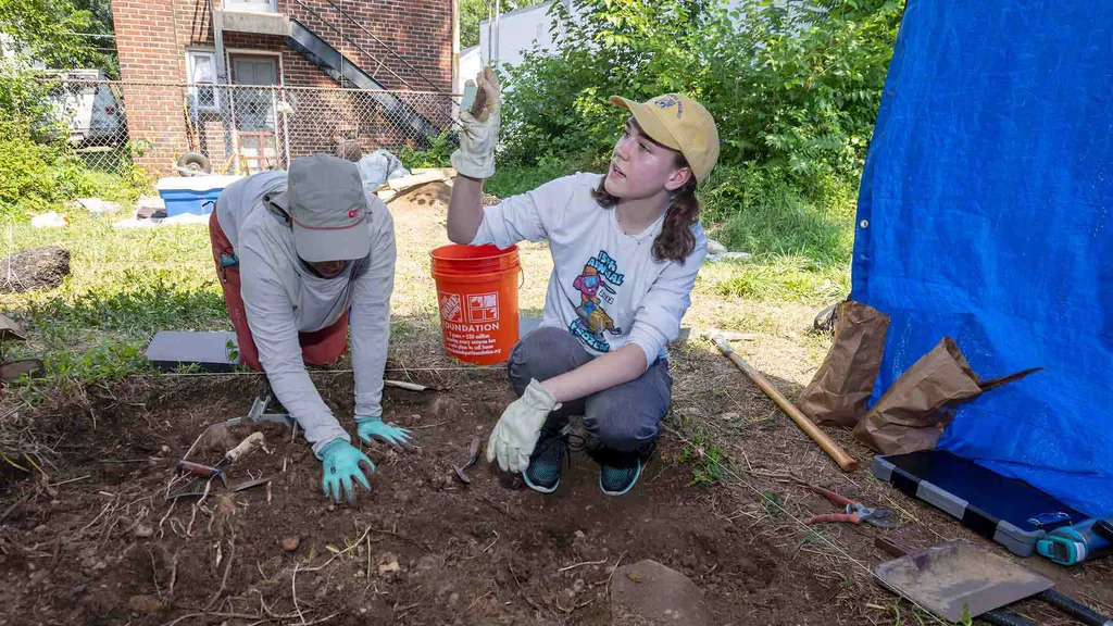 Students examine artifacts from dig