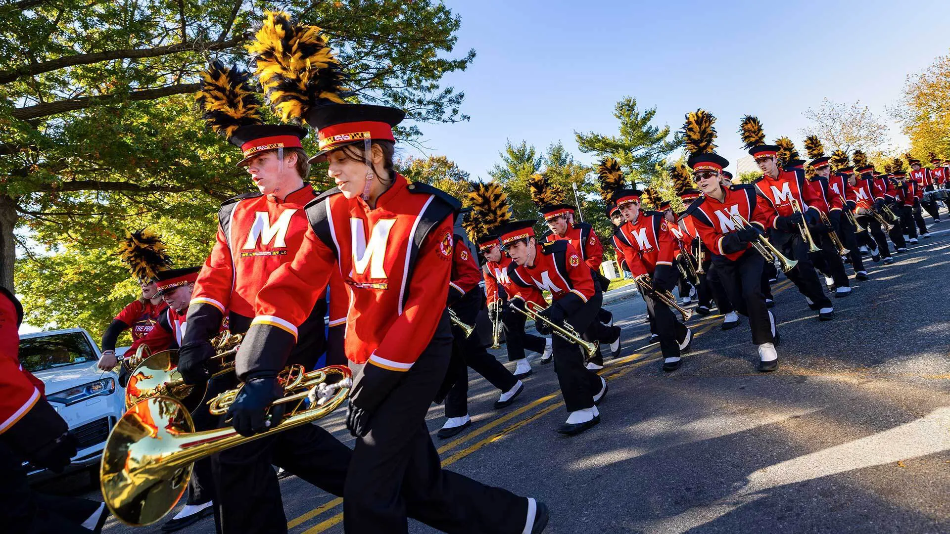 marching and in red suits marches past