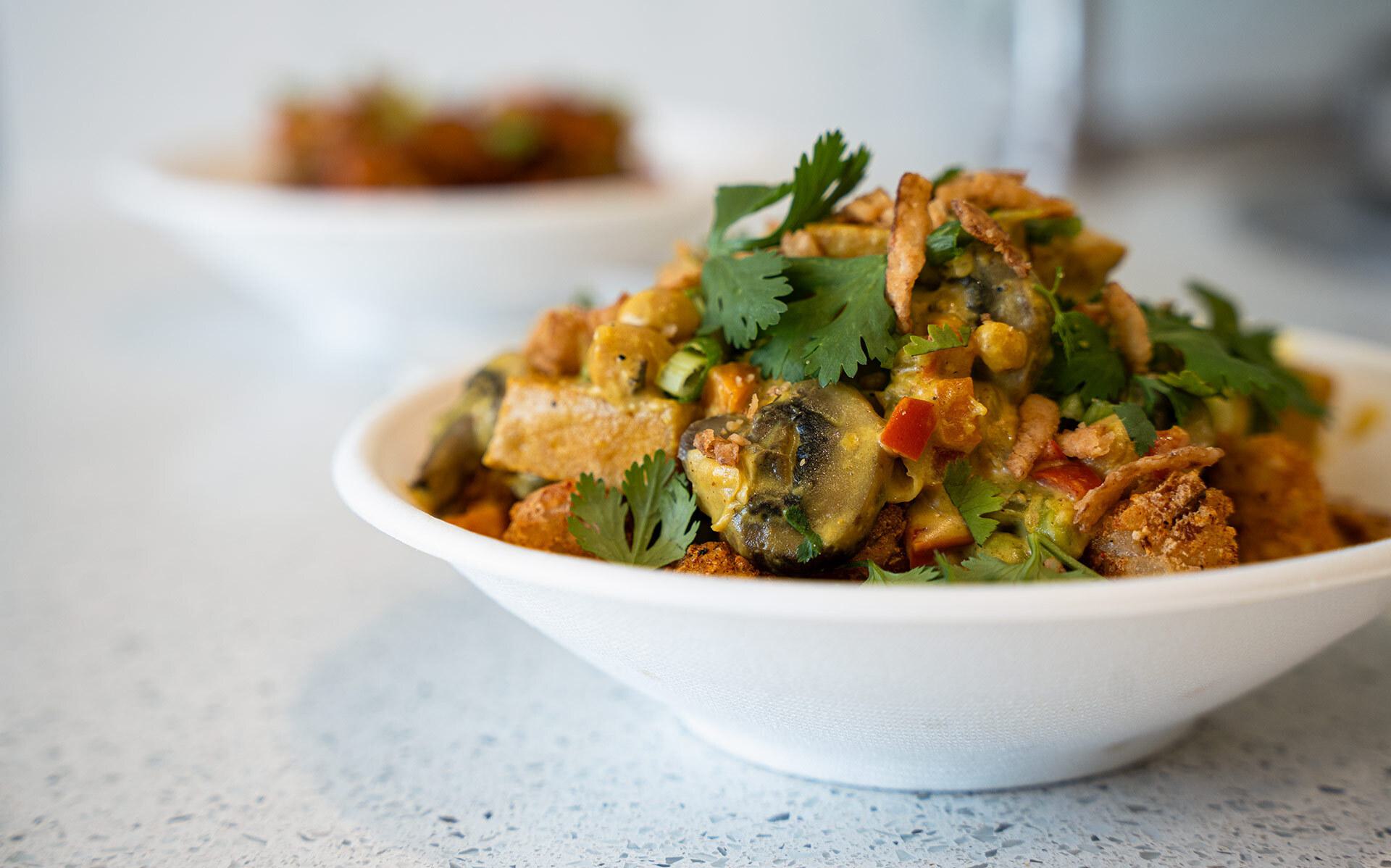 Tater tots covered in vegetable curry