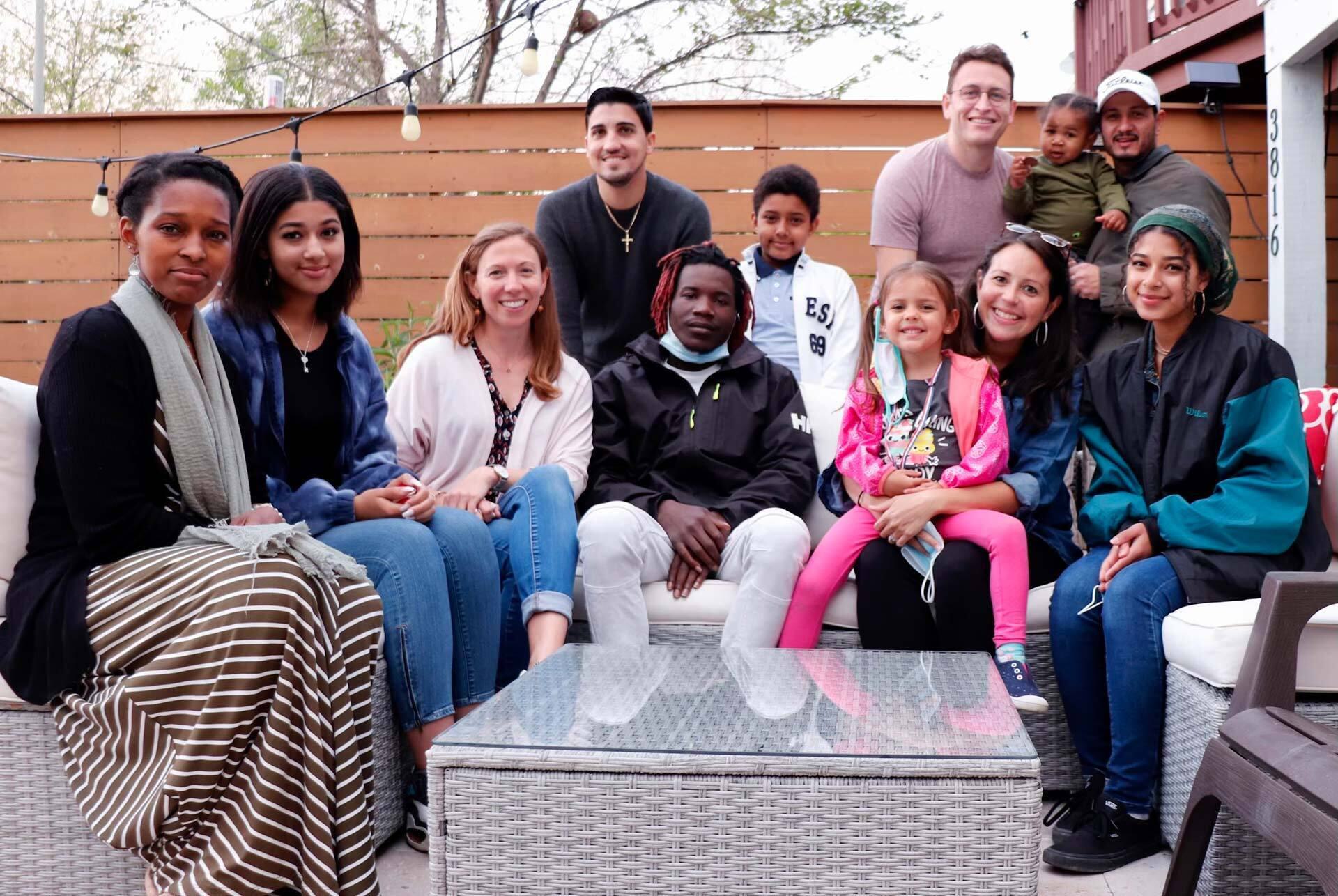 Group photo of Taylor and Madeleine Woodman with a foster child's family