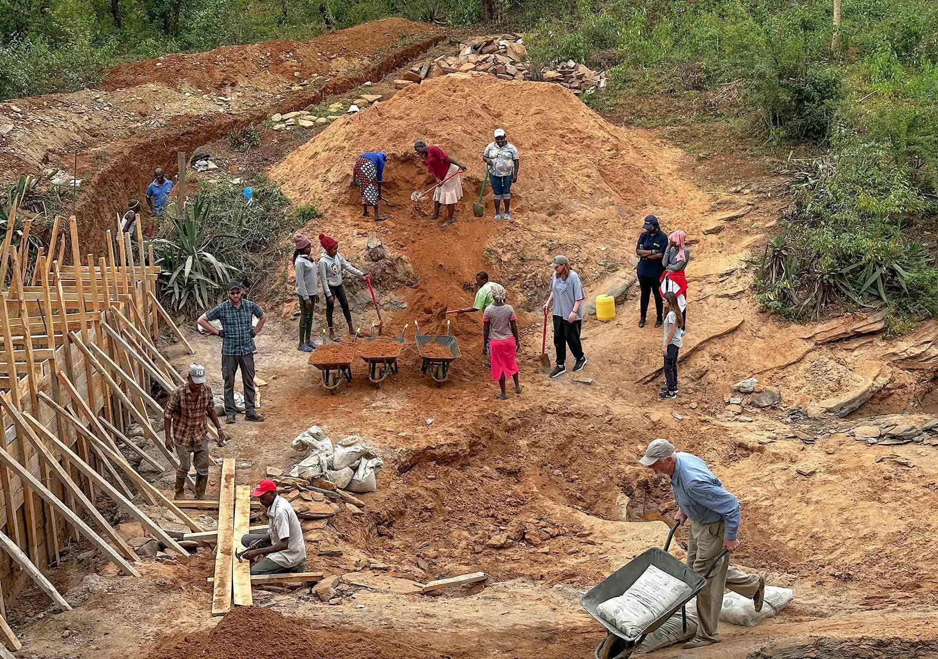 students construct sand dam