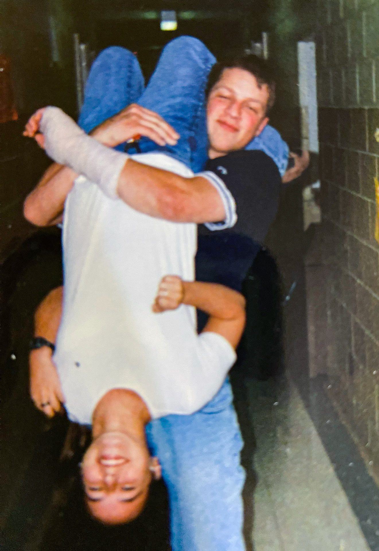 Jason ’00 Emala holds Ashley (Mandel) ’01 upside down