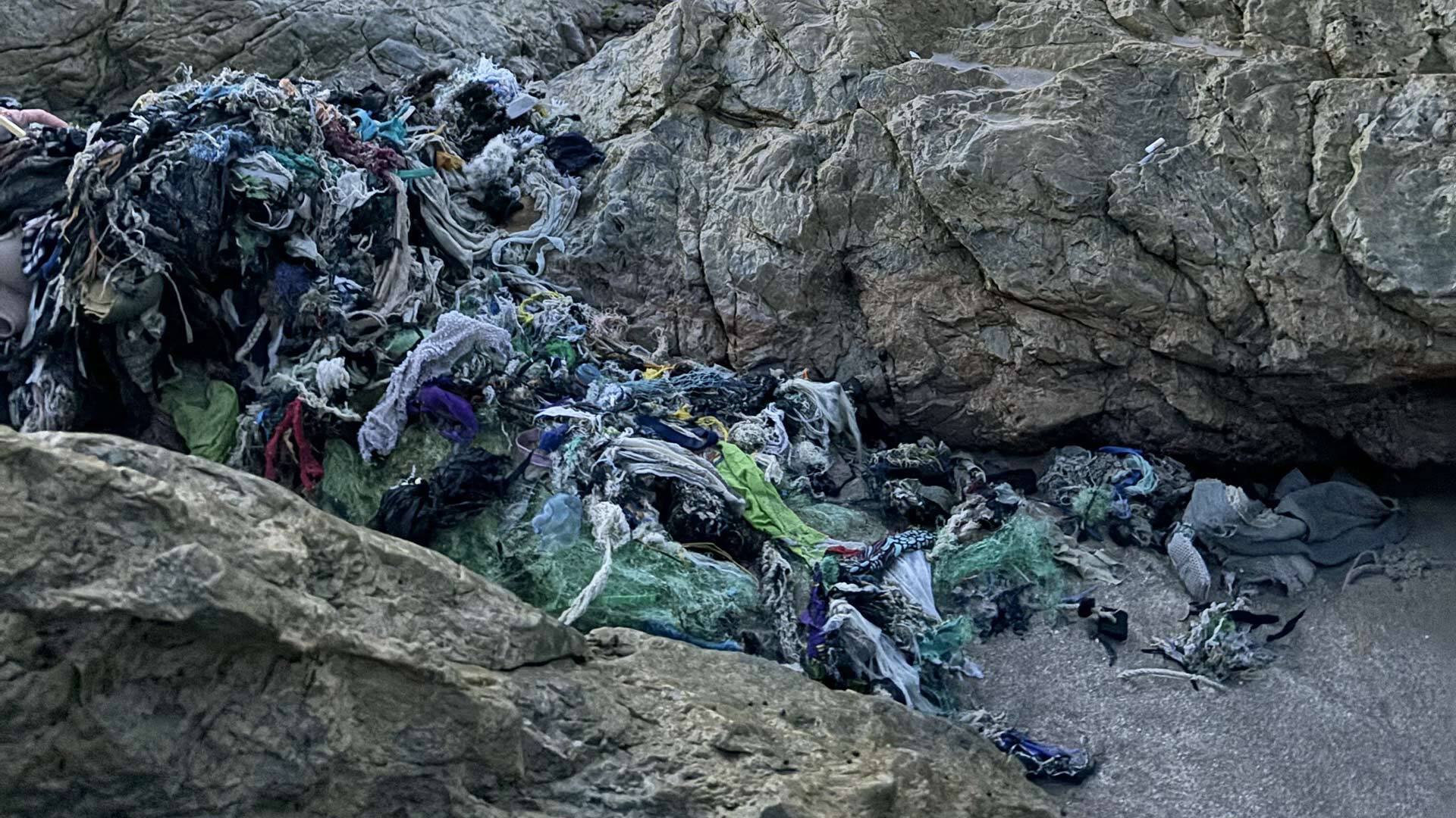 clothes washed up along rocks