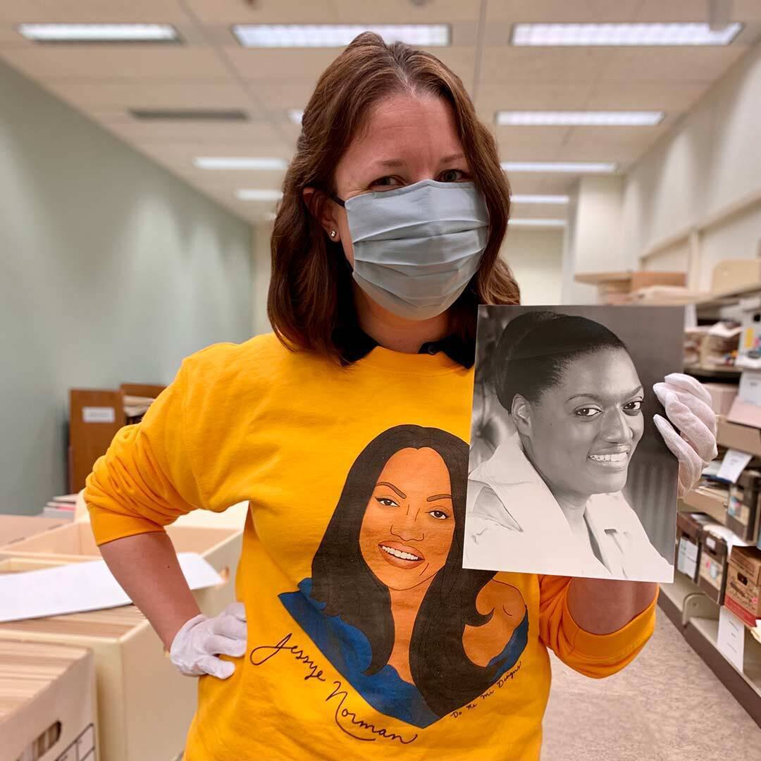 Jessica Grimmer MLIS ’21 holding picture of Jessye Norman