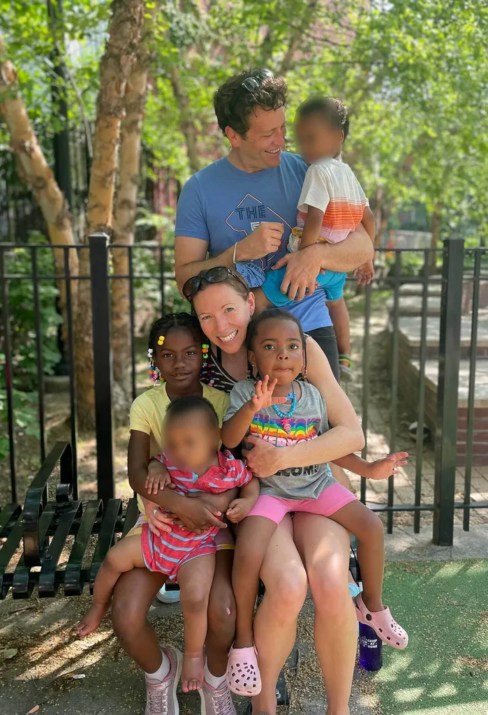 The Woodmans holding their four children in a family portrait