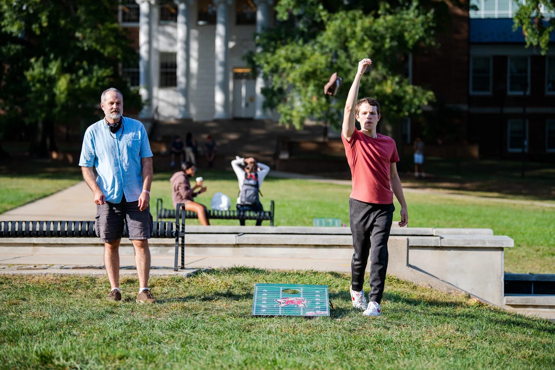 Dad and son play cornhole