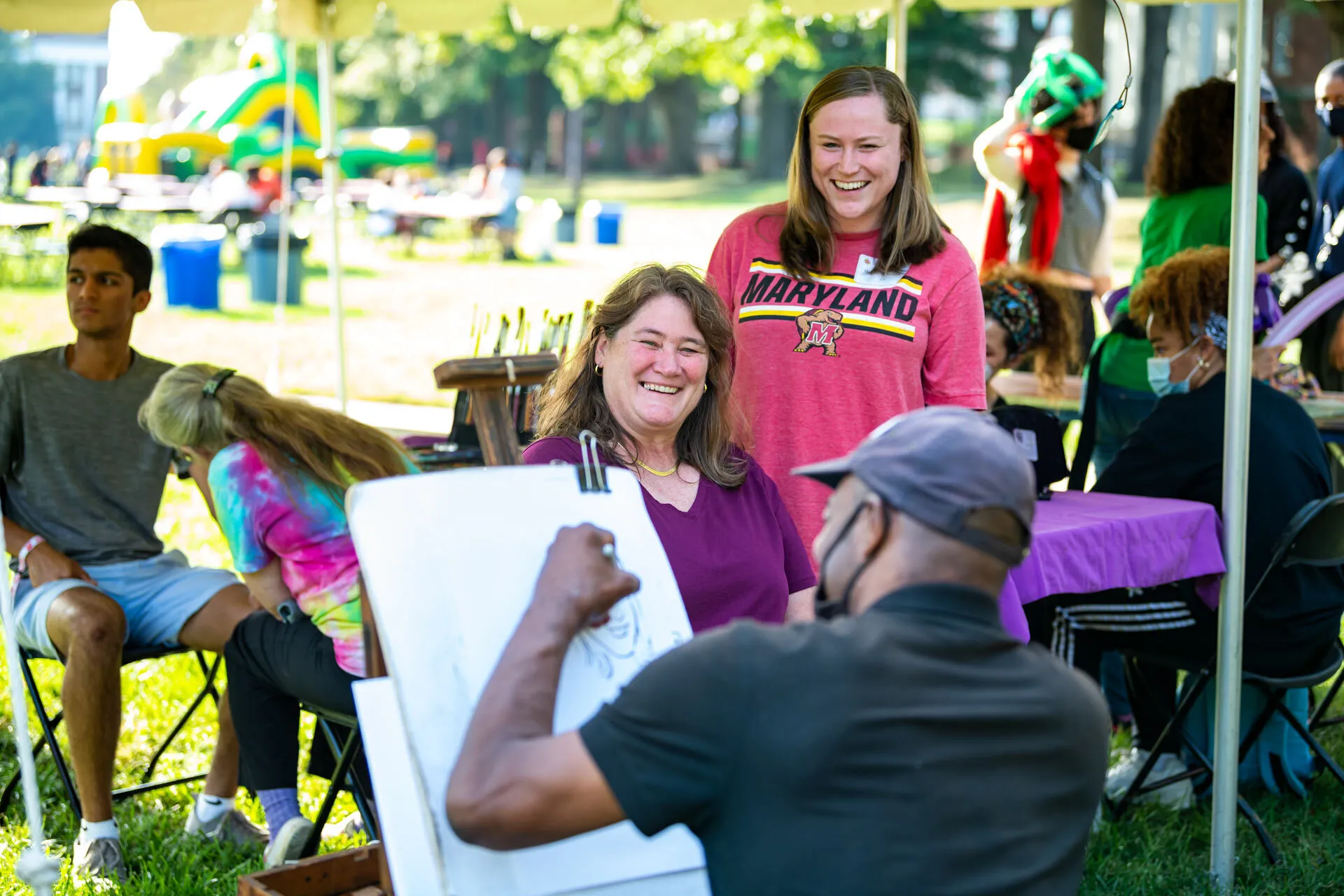 Woman gets caricature drawn on McKeldin Mall