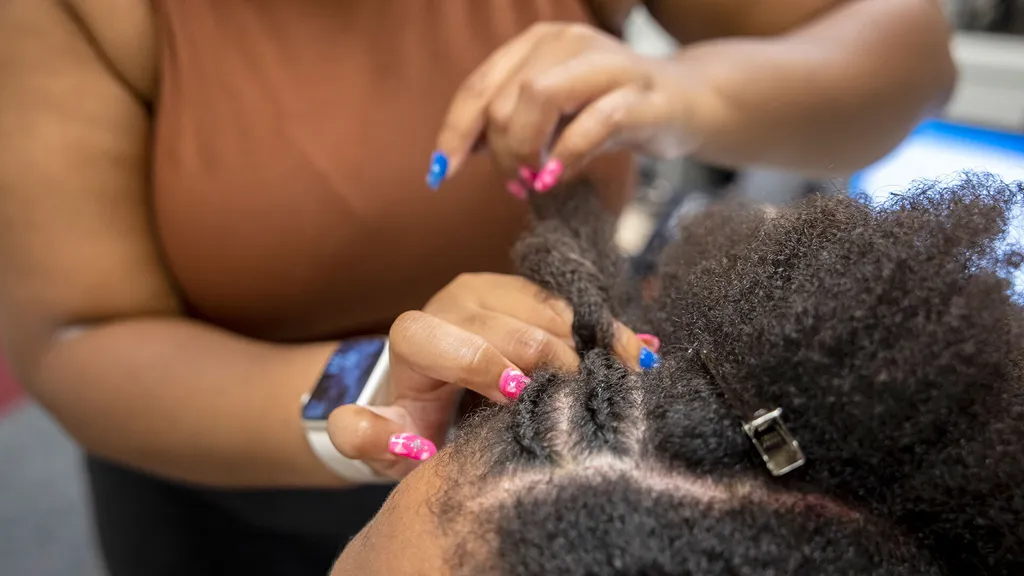 a person braids afro-textured hair