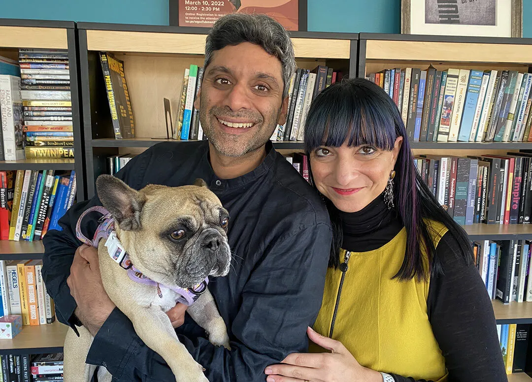 couple poses with French bulldog