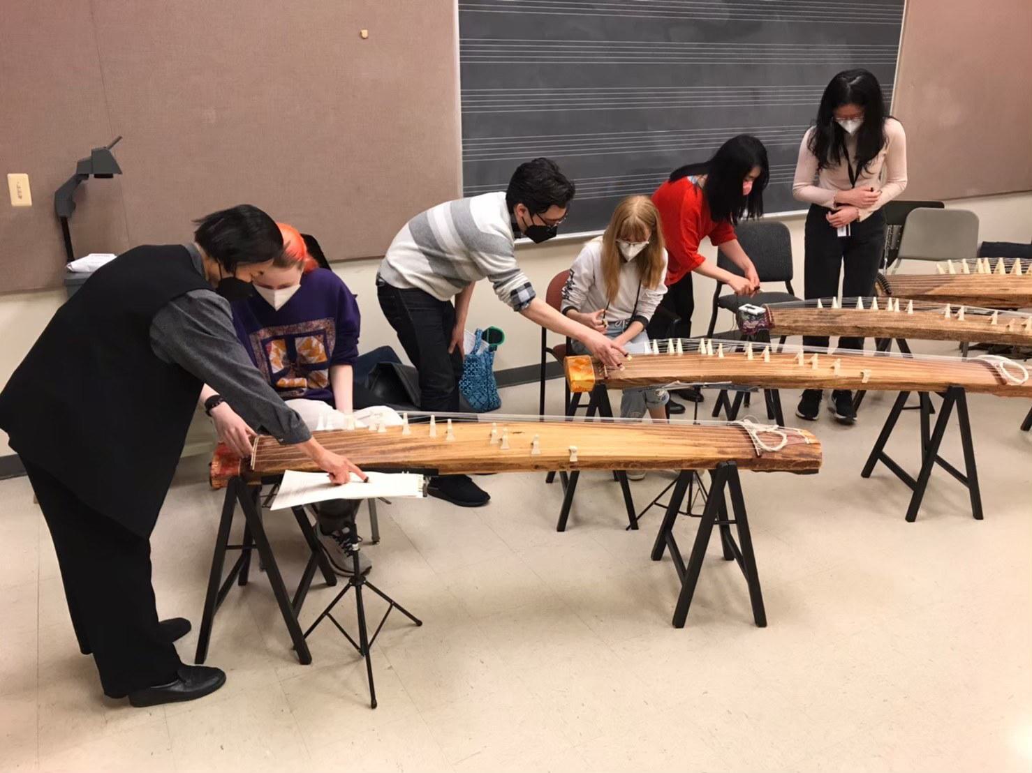 People playing Japanese string instrument called koto