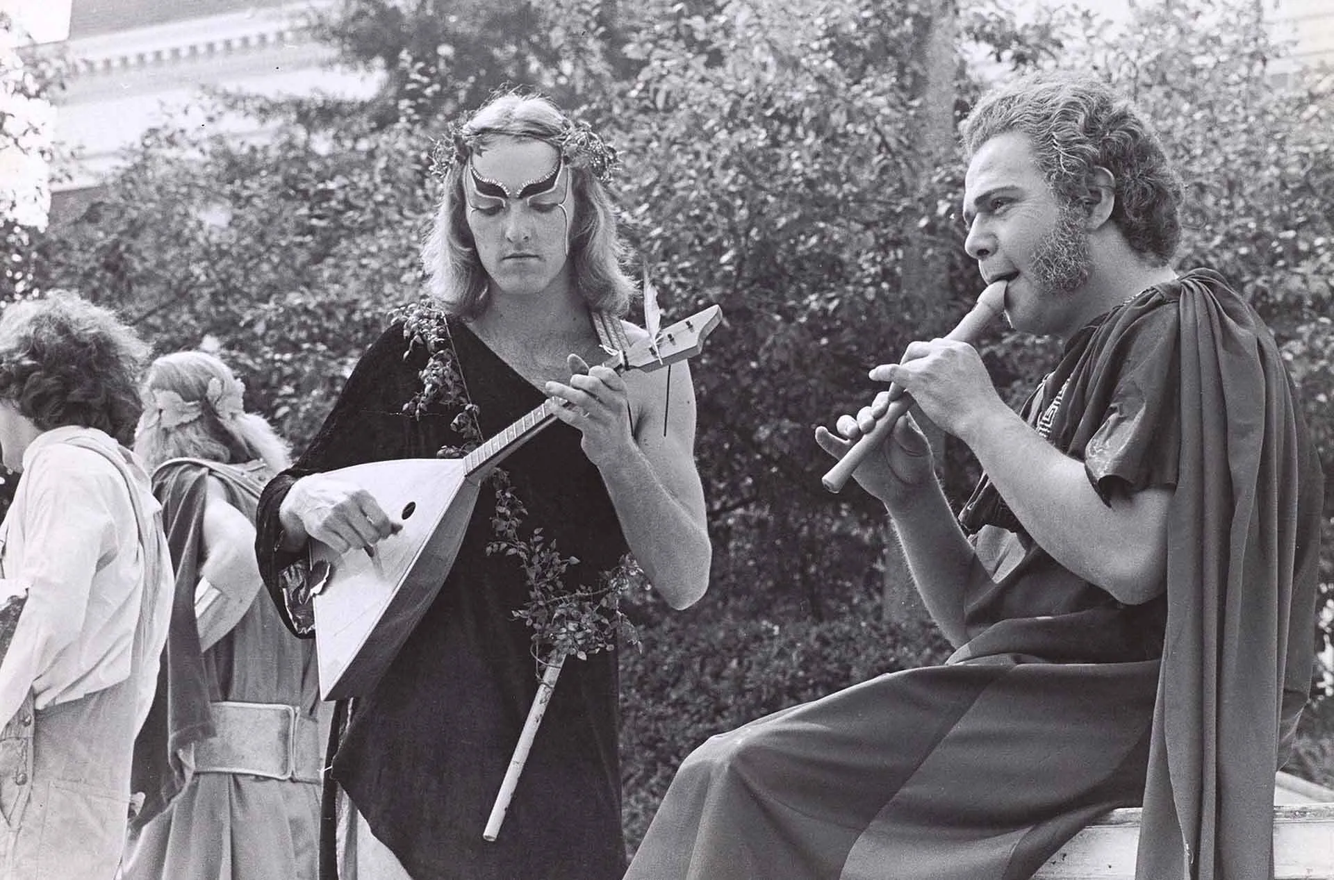two students play musical instruments