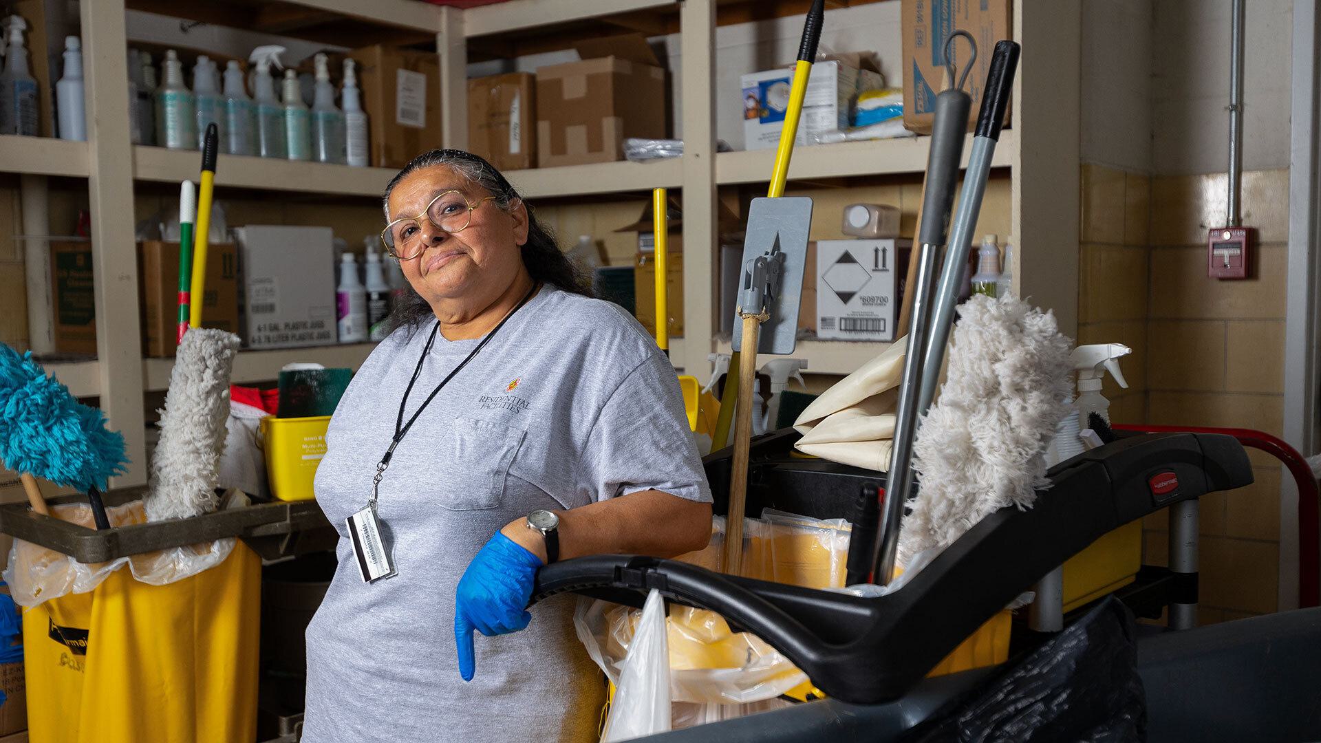 Maria Villegas poses with housekeeping supplies