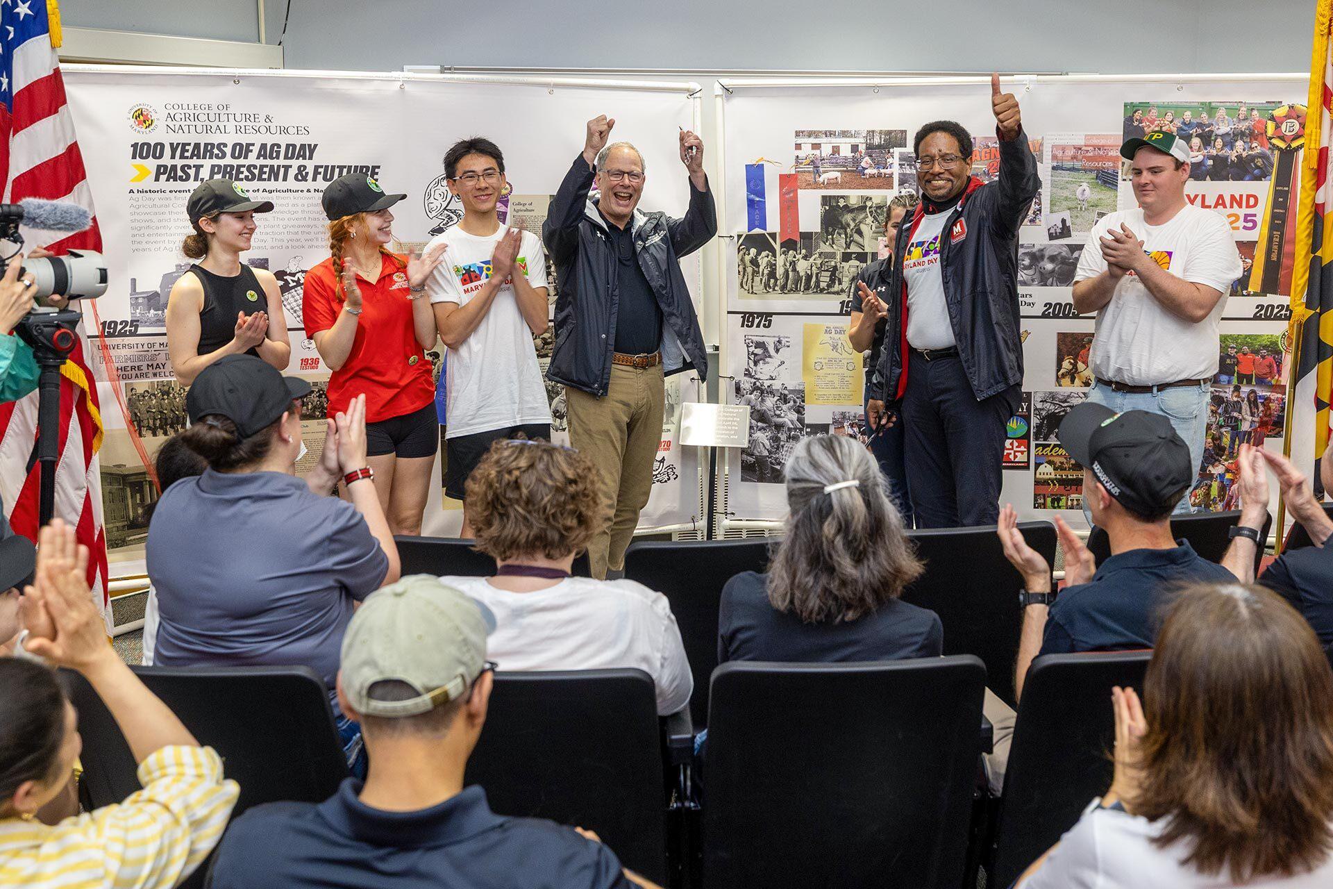 People cheer in front of a room